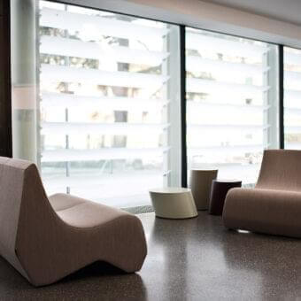 Superior LaCividina Stones sofa with organic form upholstered in warm beige textile and smooth matte finish
