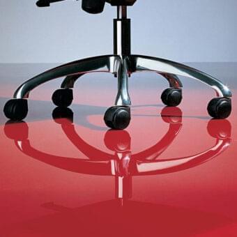 Elegant OAK Tea Armchair showcases red leather upholstery with a reflective chromed steel base mounted on five casters