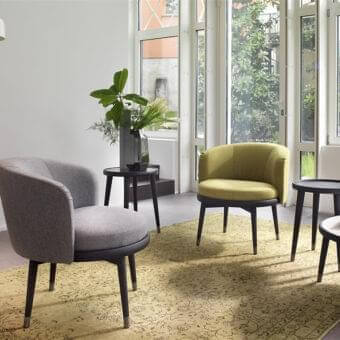 Elegant Porada Daphne lounge chair with soft fabric upholstery and dark anthracite brushed metal base