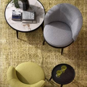 Distinctive Porada Daphne lounge chair with muted olive green fabric upholstery and wenge stained solid ash frame