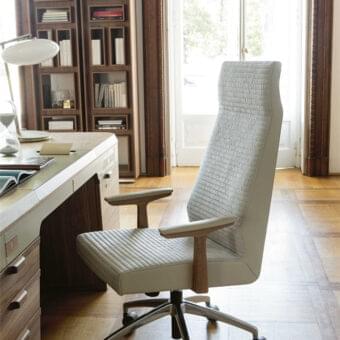 Distinguished Porada Elis armchair with a solid Canaletto walnut frame and light-colored fabric upholstery, built with a shiny aluminum base