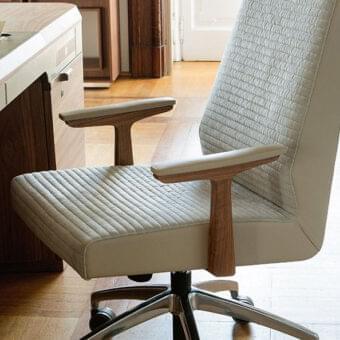 Distinctive Porada Elis armchair with Canaletto walnut armrests and light beige patterned upholstery in a shiny aluminum base