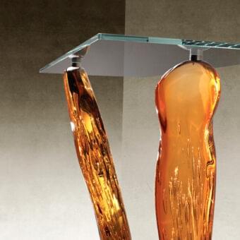 Exceptional Reflex Sassi console with amber Murano glass legs and transparent beveled glass top built upon a shiny Ebony plinth base
