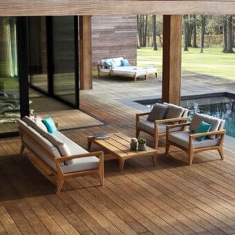 Stylish Royal Botania Zenhit lounge chair with teak wood structure and light gray cushions accented by turquoise