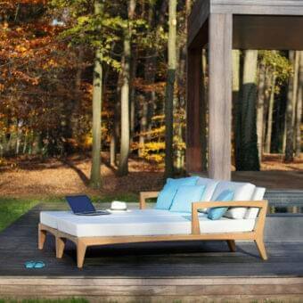 Sophisticated Royal Botania Zenhit lounger with teak wood structure and light beige fabrics displaying light blue accents