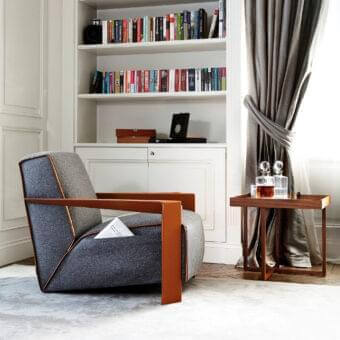 Distinguished Swan Italia Chelsea lounge chair with dark gray textured fibre upholstery and warm brown coach hide armrests with satin wood finish