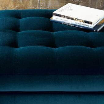 Lavish Swan Italia Hemingway ottoman with deep teal velvet-like textile and tufted top built with a wooden frame