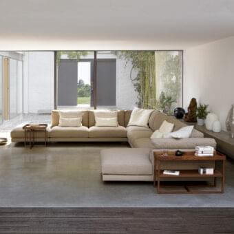 Superior Swan Italia Host sectional with neutral beige velveteen upholstery and powder-coated metal feet, including a wood side table