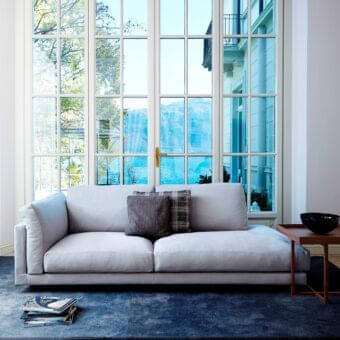 Refined Swan Italia Host sofa with light gray velveteen upholstery and subtle powder-coated metal feet