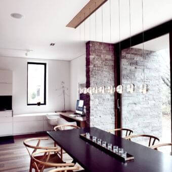 Exceptional Bocci 14 Linear Suspension Lamp composed of nine articulated cast glass pendants with frosted cylindrical voids