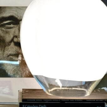 Elegant Vistosi Nessa table lamp handcrafted in transparent glass with a white upper band diffusing soft illumination