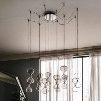 Distinguished Cattelan Italia Sablier suspension lamp in clear glass with dark-toned metal, exhibiting an organic asymmetrical form and gradient effects