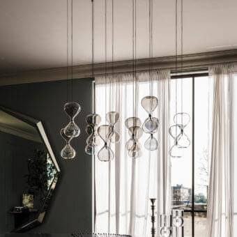 Distinguished Cattelan Italia Sablier suspension lamp in clear glass with polished metallic ceiling plate and subtle black cables