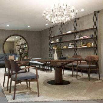 Sophisticated Porada Ella armchair with solid Canaletto walnut frame and muted gray textile seat cushion in matte finish