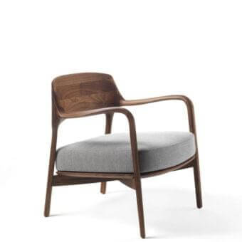 Remarkable Porada Louis lounge chair with sculpted Canaletto walnut frame and smooth light gray fabric upholstery
