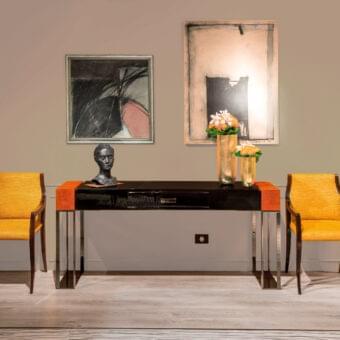 Exclusive OAK Montenapoleone console crafted with high-gloss black wood and orange-toned veneer with a polished chrome metal base and galouchat leather drawer