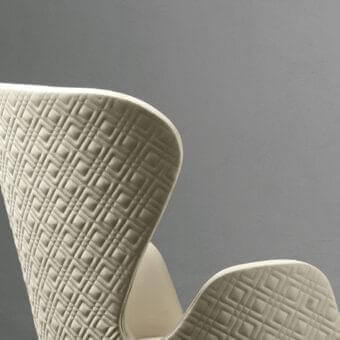 Distinctive Rugiano Aida armchair with quilted light cream textile and curved wingback silhouette crafted with wooden legs