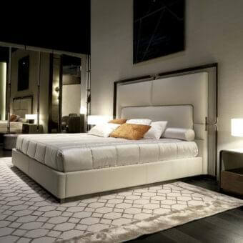 Distinguished Rugiano Grace bed with a cream textile and bronze details exhibiting a satin-finished wood frame