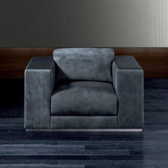 Lavish Rugiano Vogue lounge chair with dark gray-blue textured fabric upholstery and subtly-sheened arms built with a brushed steel base