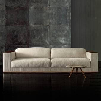 Distinguished Rugiano Vogue sofa with light neutral beige fabric upholstery and satin-finish wood frame featuring ribbed textile paneling