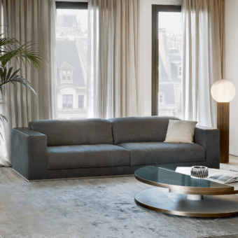 Superior Rugiano Vogue sofa presents a modern aesthetic upholstered in muted gray textile with a matte finish and visible steel details