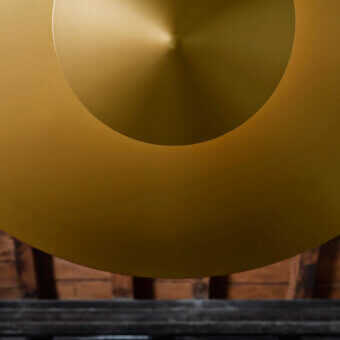 Elegant Penta Narciso suspension lamp with concentric discs crafted in matte metal and warm golden finish