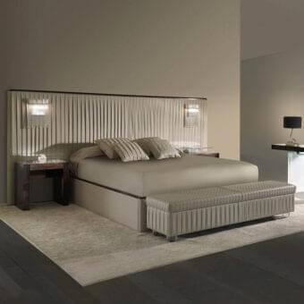 Distinguished Reflex Plissé XL bed with upholstered headboard and frame in muted beige textile with shiny metal and ebony wood accents