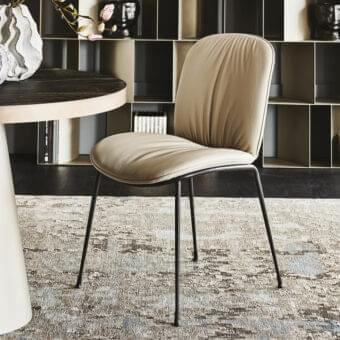 Elegant Cattelan Italia Tina chair with a titanium steel frame and neutral beige fabric upholstery featuring a curved silhouette