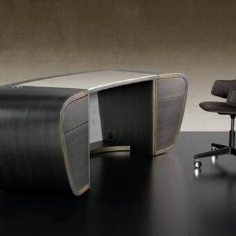 Distinguished Reflex Segno desk with curved lacquered wood, leather Naturale covering and metal accents, showcasing a stained finish
