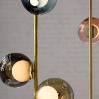 Distinguished Bocci 28 Stem Ceiling Lamp with slender brass stems supporting uniquely distorted glass spheres in gradient gray, blue, and pink hues