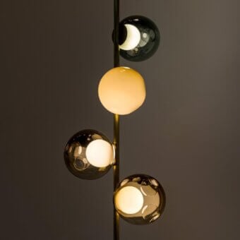Sophisticated Bocci 28 Stem Floor to Ceiling Lamp with clear glass exterior and milk white interior crafted with a refined black finish