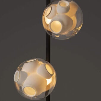 Distinguished Bocci 38V Stem floor lamp with clear glass exterior and milk white interior crafted in a brass finish