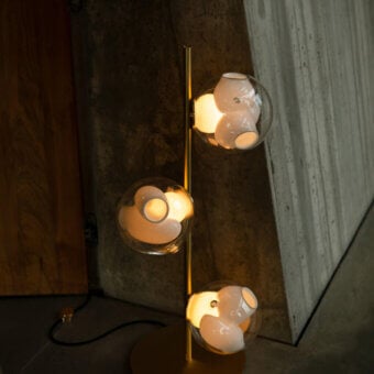 Elegant Bocci 38V Stem floor lamp with brass and clear glass crafted with a milk white interior and polished finish