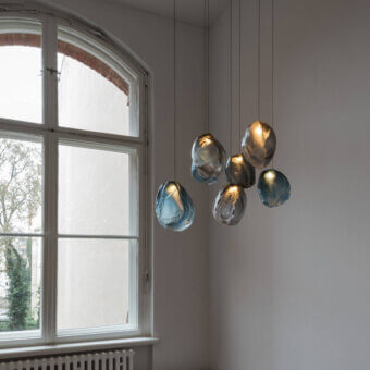 Captivating Bocci 73V single suspension lamp crafted in molten glass with blue gradient and brushed nickel canopy