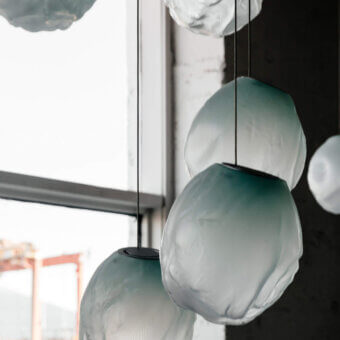 Distinguished Bocci 73V single suspension lamp in muted teal glass with braided metal coaxial cable and brushed nickel canopy