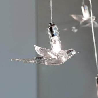 Exclusive Reflex Rondini suspension lamp with delicate swallow pendants crafted in transparent and black Murano glass with glossy finish