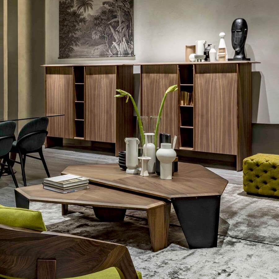 Walnut coffee table with black base, Porada sideboard with wood grain, lime green ottoman, gray rug, foliage photograph, modern living room.