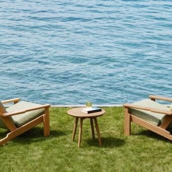 Sophisticated Varaschin Bali Bergere lounge chair with light Teak wood and soft green textile cushions crafted in Italy