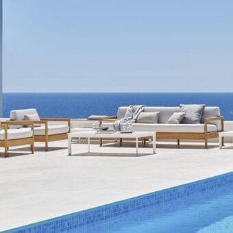 Lavish Varaschin Bali lounge chair with light teak wood and smooth cushions in light gray offering essential comfort