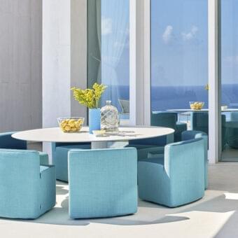 Superior Varaschin Big In&out table and chairs set with white HPL tabletop and light blue woven textile upholstery built with okoumè wood