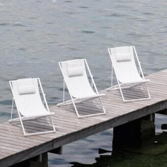 Refined Varaschin Clever Lounger lounge chair with white powder-coated aluminum and white synthetic fabric seat built with an integrated headrest