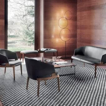 Innovative Potocco Velis lounge chair with sleek black upholstery and a visible solid ash frame