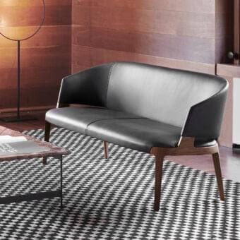 Exceptional Potocco Velis sofa with enveloping form built in dark leather and medium-tone Canaletto walnut or ash with satin finish