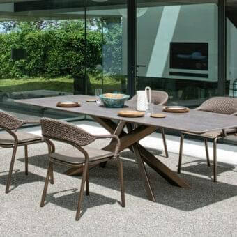 Innovative Varaschin System Star table with dark gray textured HPL top and powder-coated aluminum base built with rhomboidal legs