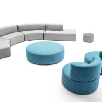 Elegant Varaschin Belt lounge chair with rounded shape and okumè wood structure in uniform blue upholstery