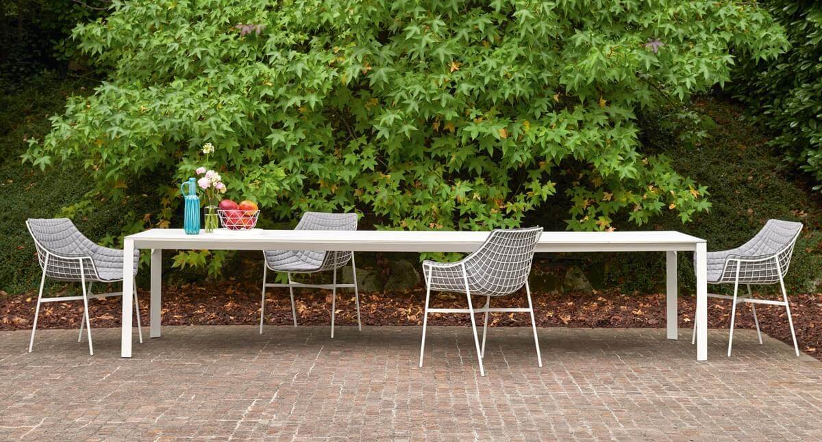 Elegant Varaschin Summer Set armchair with a powder-coated steel grid frame and gray textile cushion built in Italy