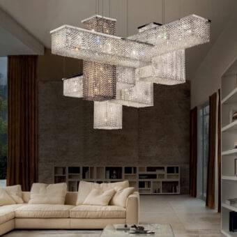 Innovative Masiero Cubo suspension lamp with a shiny chrome metal frame and transparent crystal pendants creates a cascading illumination