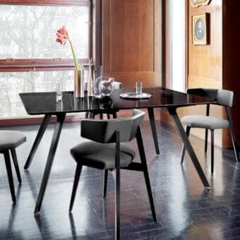 Elegant Potocco Katana indoor table with dark reflective glass tabletop and dark-toned wood legs
