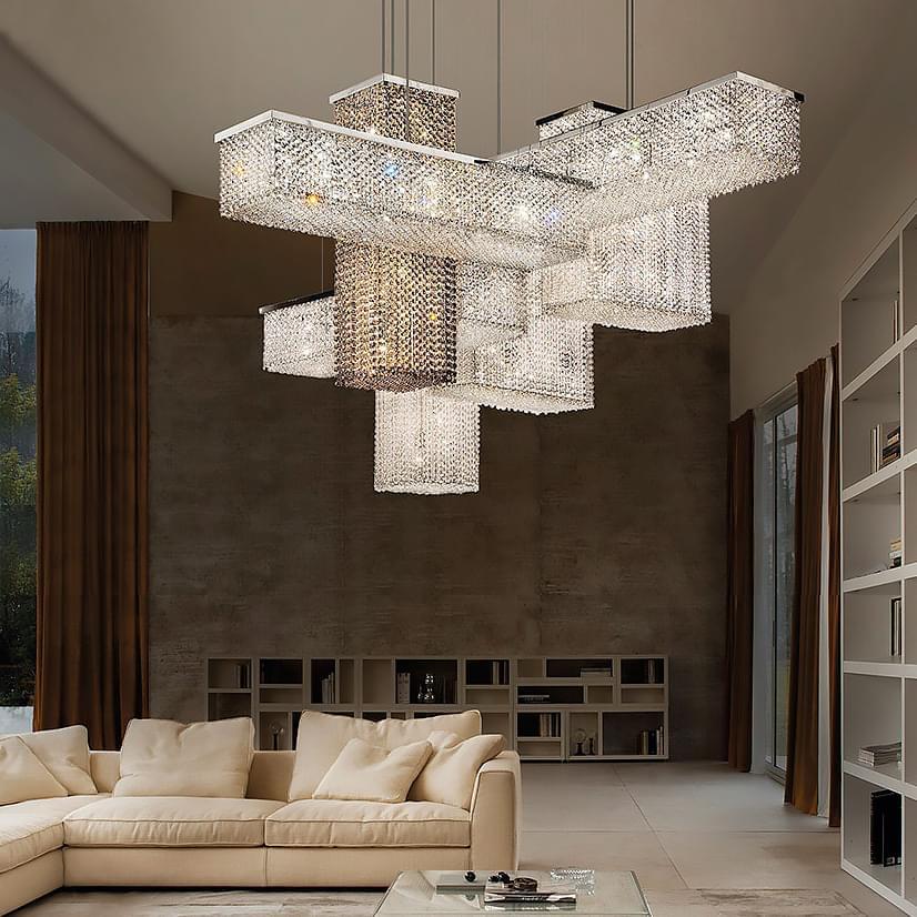 Crystal chandelier with rectangular modules in a contemporary living room featuring a beige sectional, brown curtains, and light wood flooring.