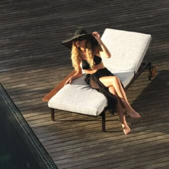Exceptional Talenti Casilda lounger with a dark powder-coated stainless steel frame and light gray textured textile cushioning